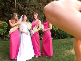 Delightful young girlfriends are hotly kissing and fondling each other at wedding